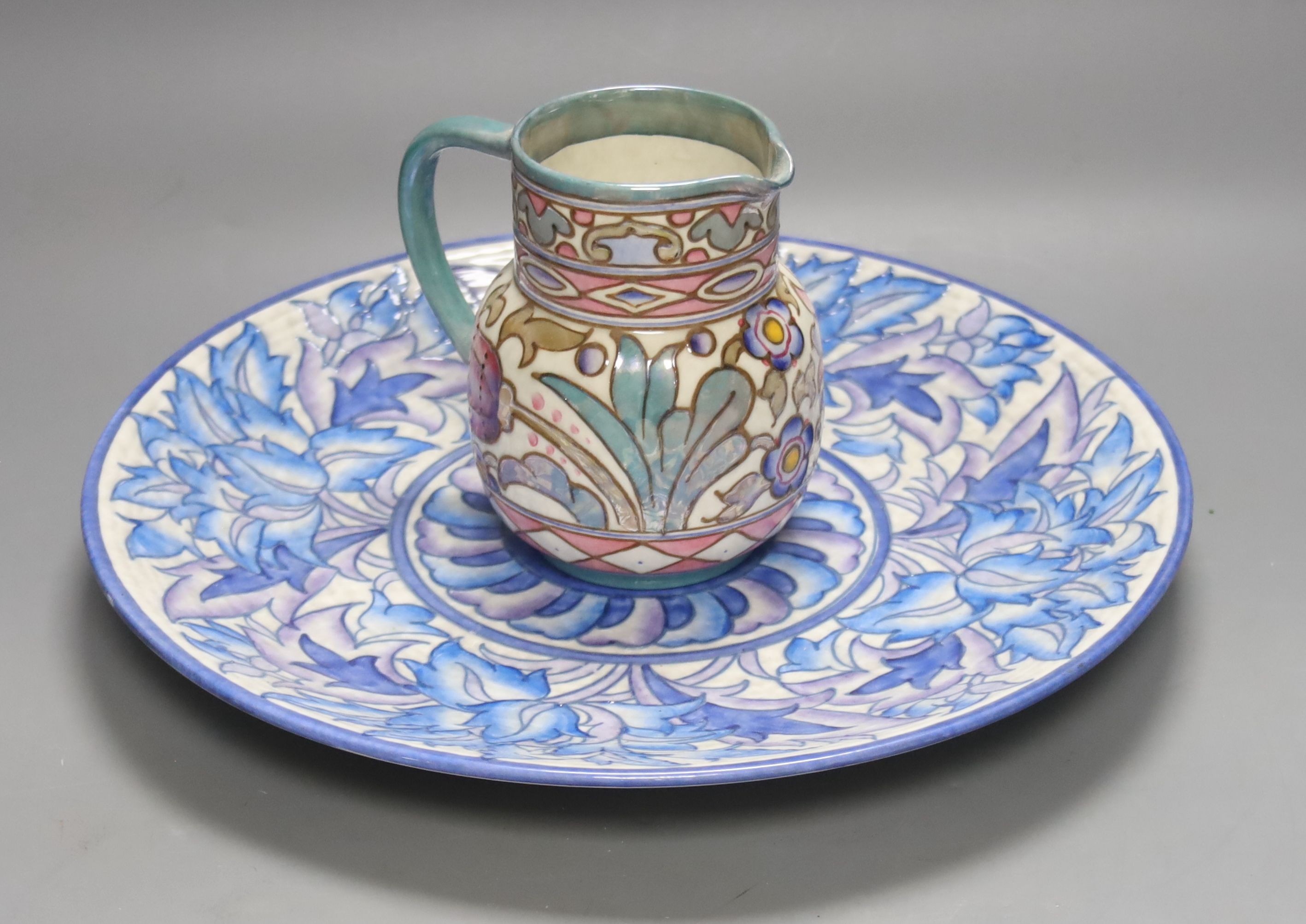 A Burleigh ware Charlotte Rhead lustre jug and a Crown Ducal dish, diameter 32cm